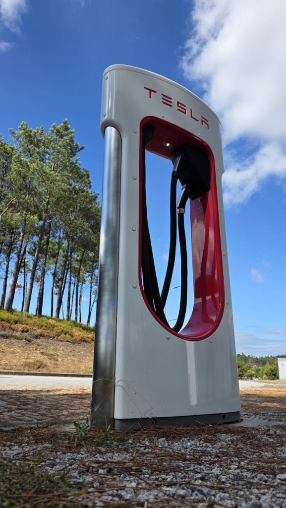 Tesla Supercharger station under a clear blue sky in Ribeira de Pena, Portugal.